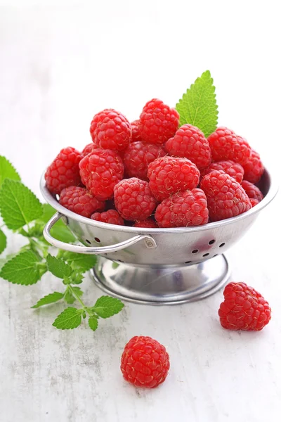 Fresh raspberries in colander — Stock Photo, Image