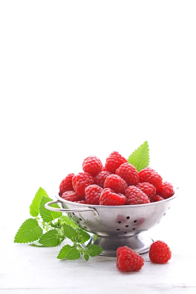 Fresh raspberries in colander — Stock Photo, Image