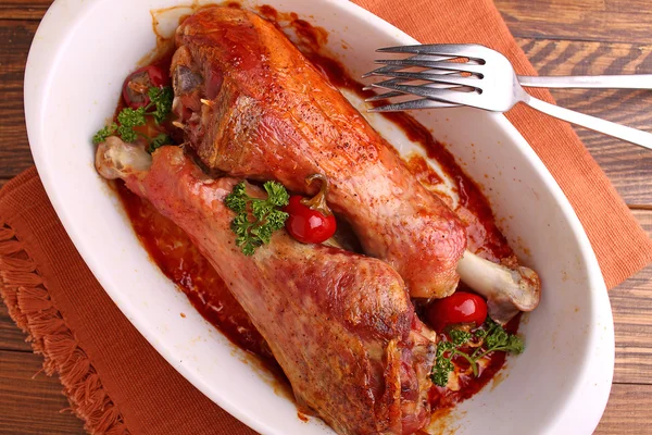 Baked turkey legs in white plate on dark background — Stock Photo, Image