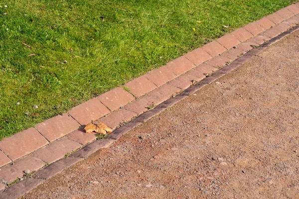Mowed Lawn Red Dust Pedestrian Path Tiled Rainwater Gutter — Stock Photo, Image