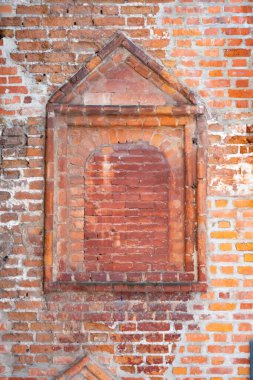 A vaulted niche laid with kipich for an icon in an old wall, red brick laying, background