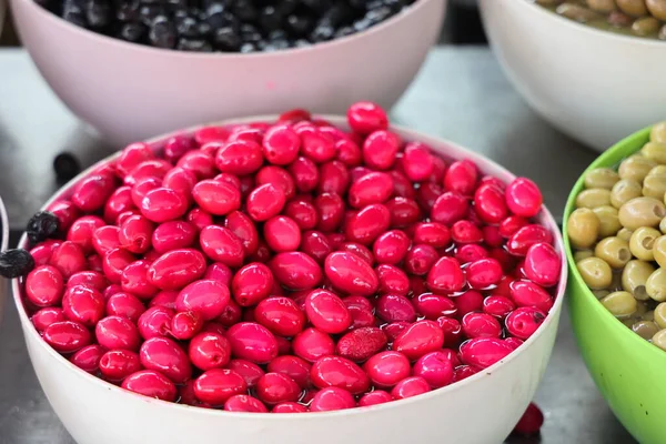 Pink pickled olives in white bowls at the oriental bazaar, Alanya, Turkey, April, 2021