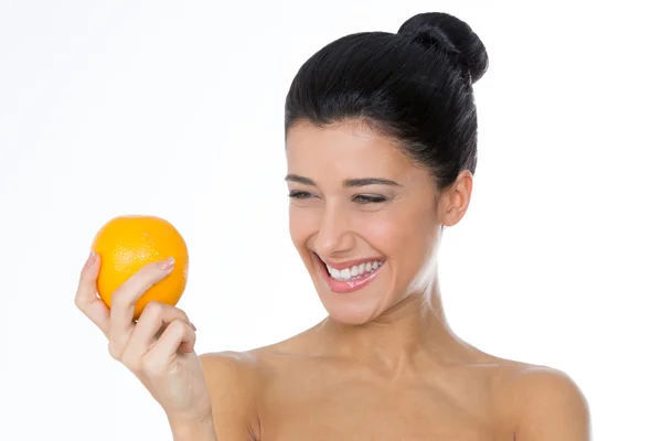 Smiling girl looking at an orange — Stock Photo, Image