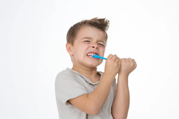 Boy is hurting while cleaning teeth — Stock Photo, Image