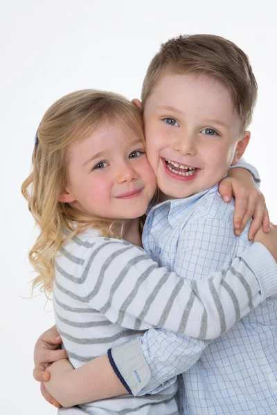 Children hugging on white background — Stock Photo, Image