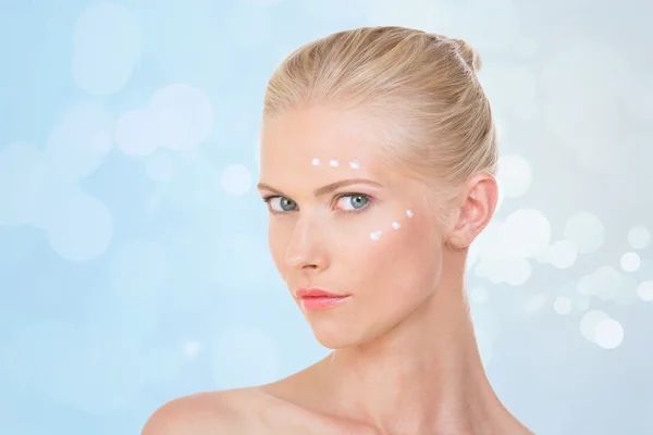 Blond woman testing salve on her face — Stock Photo, Image