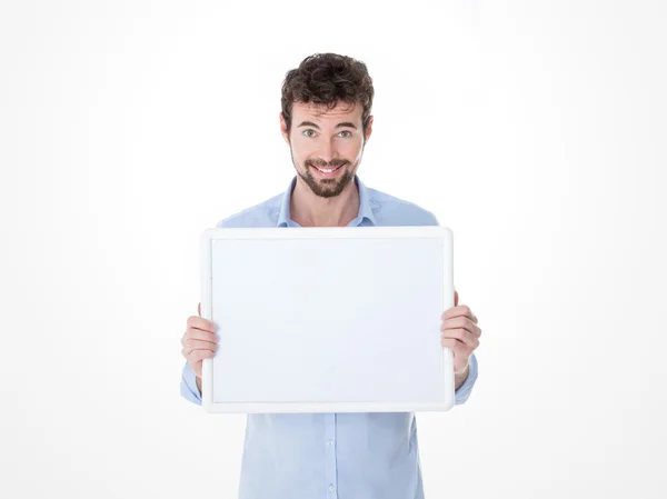 Smiling young man holding an empty board — Stock Photo, Image