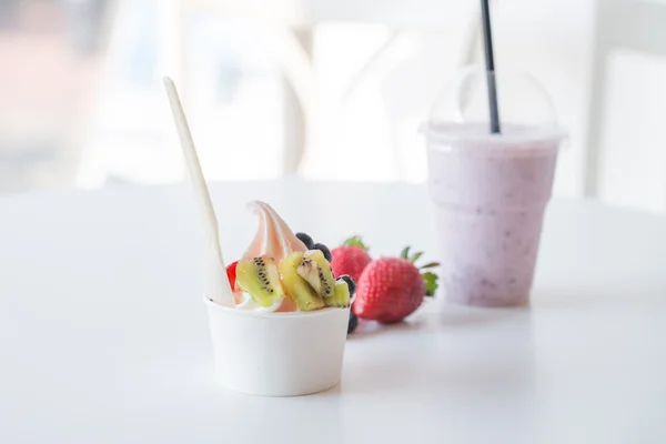 Smoothie in plastic cup and frozen yougurt with fruits — Stock Photo, Image