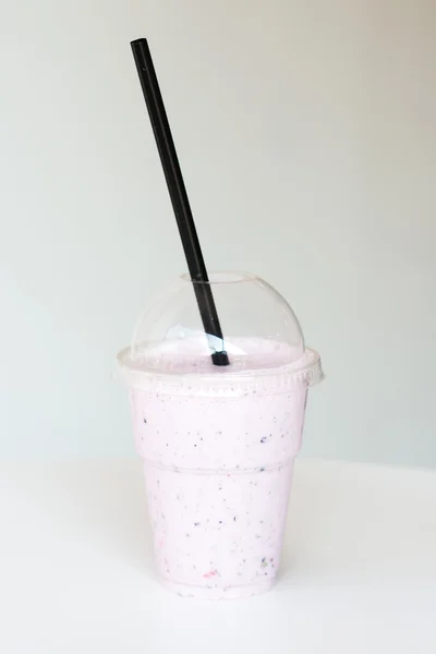 Smoothie in plastic cup at the table — Stock Photo, Image