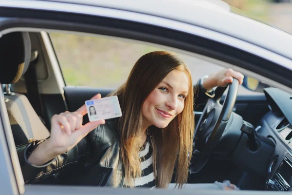 Aantrekkelijke jonge vrouw trots tonen haar bestuurders licentie — Stockfoto