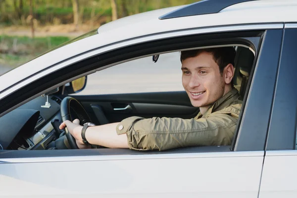 Handsome man in white car — Stock Photo, Image