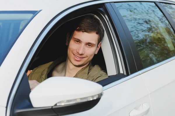 Handsome man in white car — Stock Photo, Image