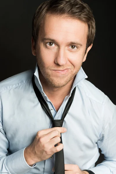 Handsome man in blue shirt and tie looking at camera — Stock Photo, Image