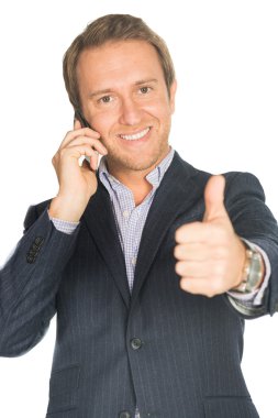 Takım elbiseli yakışıklı adam cep telefonu gösterir yumruk üzerinde konuşuyor