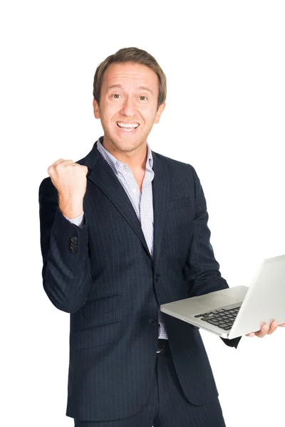 Knappe man in pak erg blij met laptop — Stockfoto