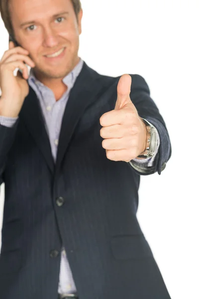 Handsome man in suit speaks on the mobile phone shows thump up — Stock Photo, Image