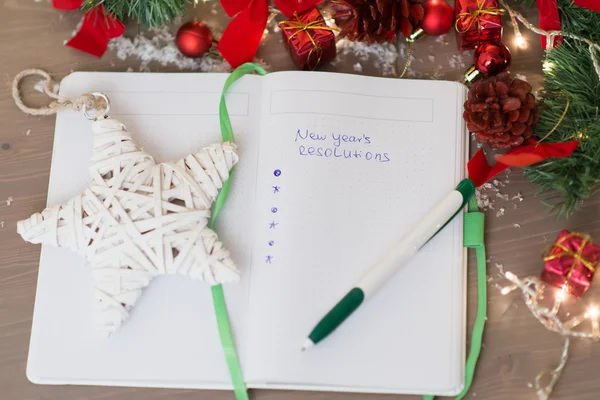 New year's resolutions written on a notepad with a star and new — Stock Photo, Image