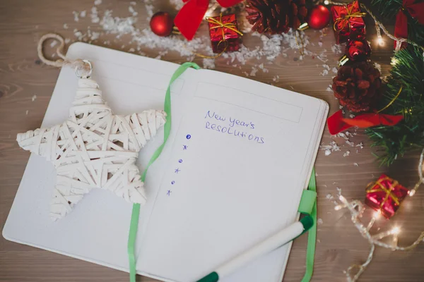 New year's resolutions written on a notepad with a star and new — Stock Photo, Image