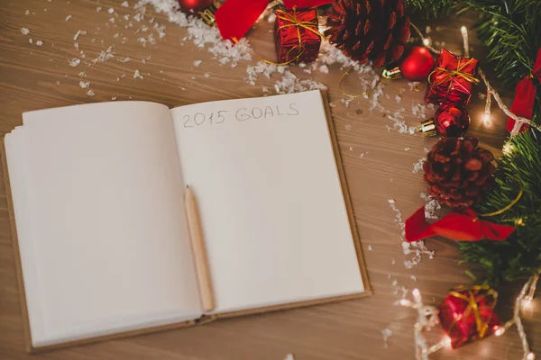 Notepad with a pensil and xmas decoration written 2015 goals — Stock Photo, Image