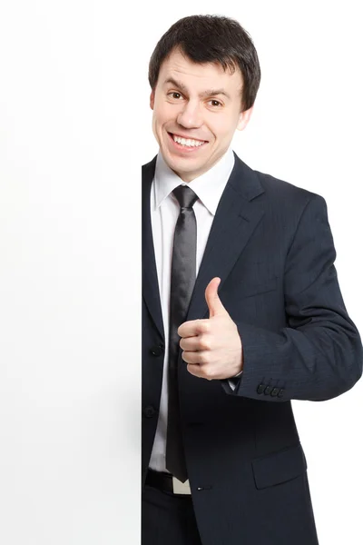 Бізнесмен ізольований на білому з рекламною дошкою показує великий палець вгору — стокове фото