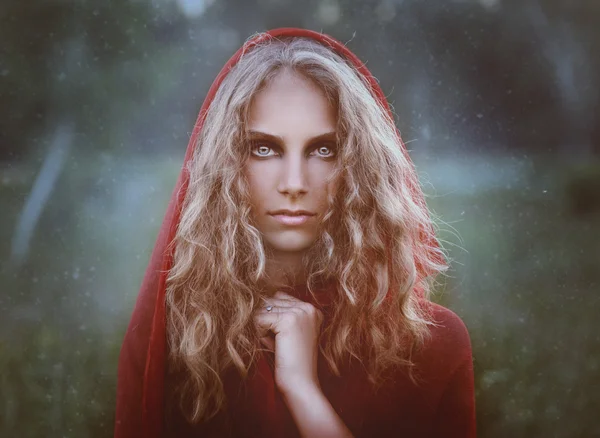 Portrait of beautiful woman in red hood — Stock Photo, Image