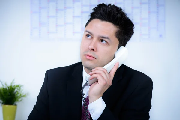 Attractive business man in office speaking at telephone — Stock Photo, Image