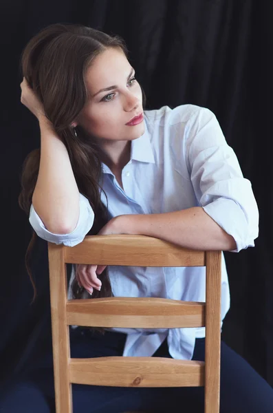 美丽的女人坐在椅子上的肖像 — 图库照片