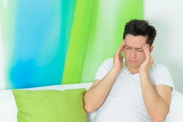 Young man has a headache — Stock Photo, Image