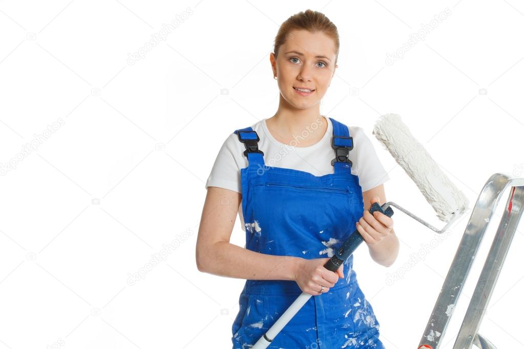 Beautiful young woman doing repairs in blue coverall