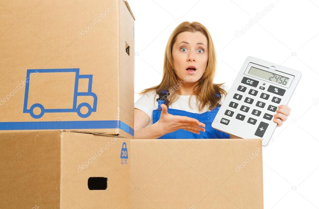 Woman with moving boxes with big calculator