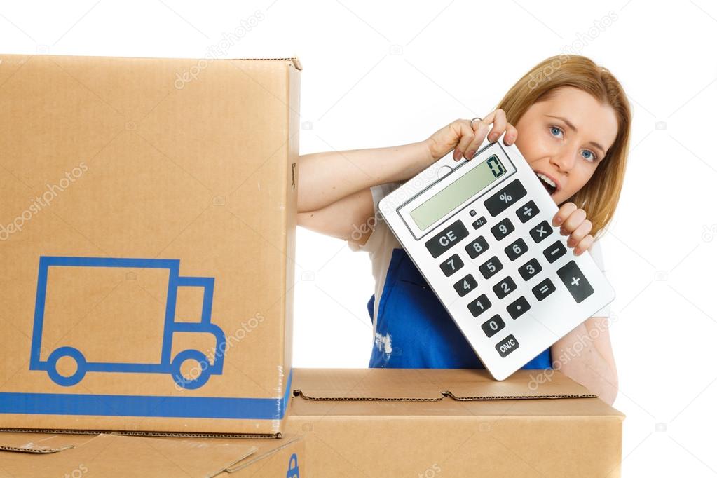 Woman with moving boxes with big calculator