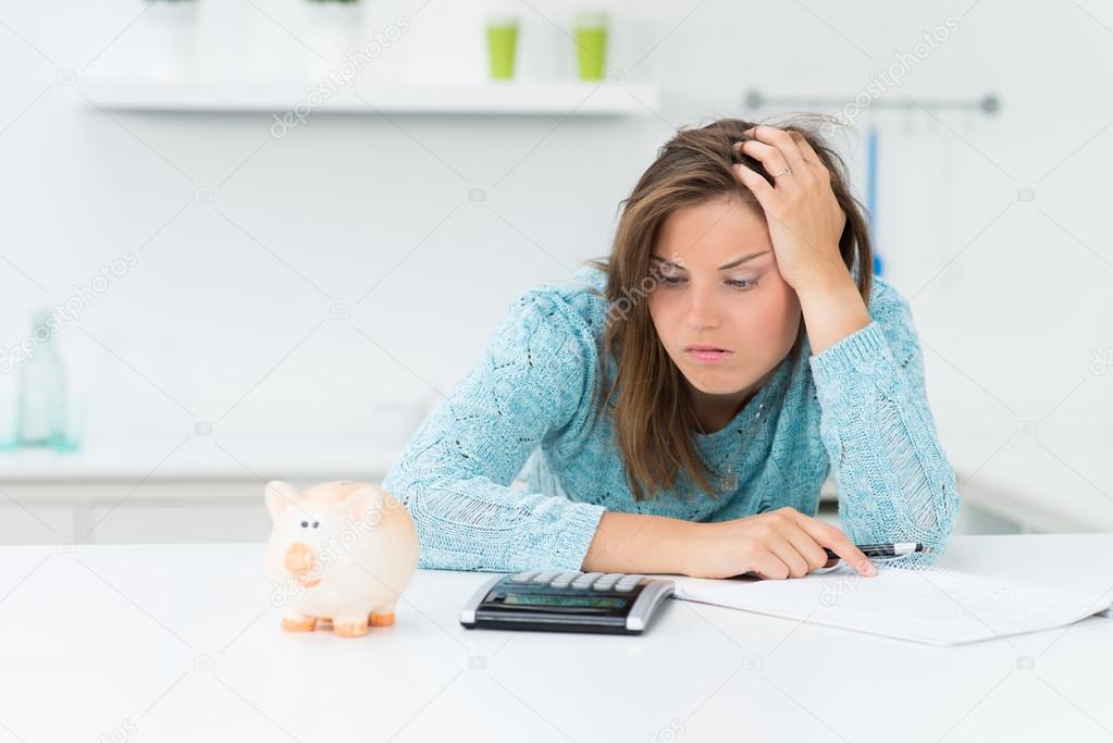attractive woman calculating houshold costs