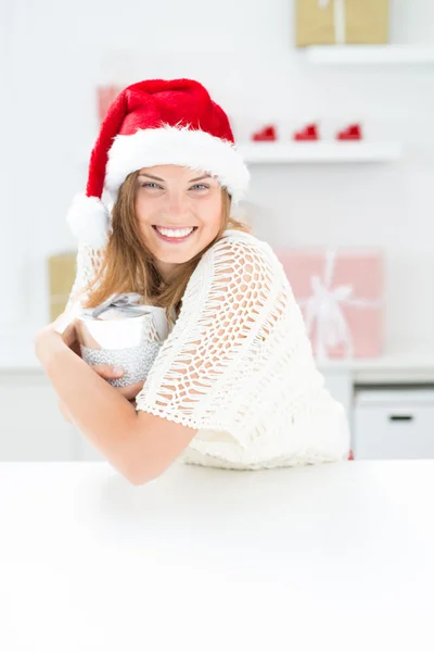 Beautiful woman in Santa Claus hat gets a present — Stock Photo, Image