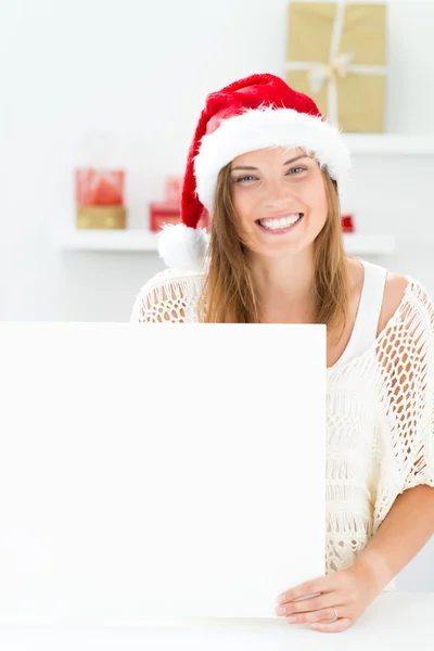 Santa girl peeking from behind blank sign billboard. Advertising — Stock Photo, Image