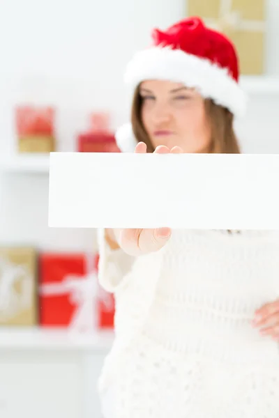 Santa girl peeking from behind blank sign billboard. Advertising