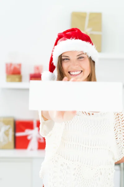 Santa girl peeking from behind blank sign billboard. Advertising — Stock Photo, Image