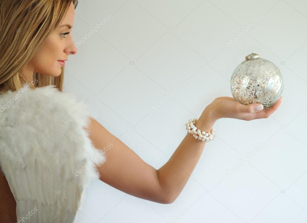 angel with decorative ball in hand