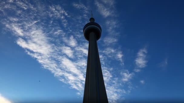 The CN Tower in silhouette with a lightly clouded sky — Stock Video