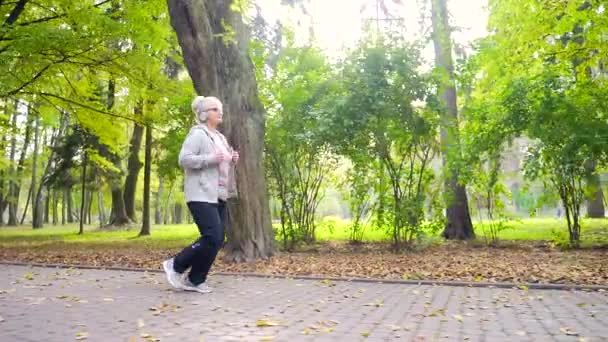 Portrait Active Senior Woman Running Alley Park Forest Nature Listening — Stock Video