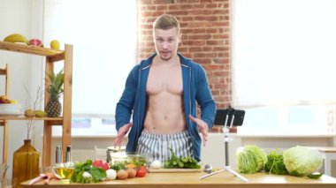 Blogger sporcusu, antrenörü veya eğitmeni çevrimiçi söylüyor. Fitness elemanı sağlıklı beslenmeyle ilgili bir akıllı telefon kamera dersi kaydediyor. Vücut geliştirici için diyet. Evde, mutfakta yapılan yoğun antrenman sırasında.