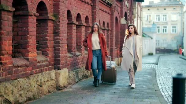 Two Young Women Tourists Walk Street Old Town Suitcase Gift — Stock Video