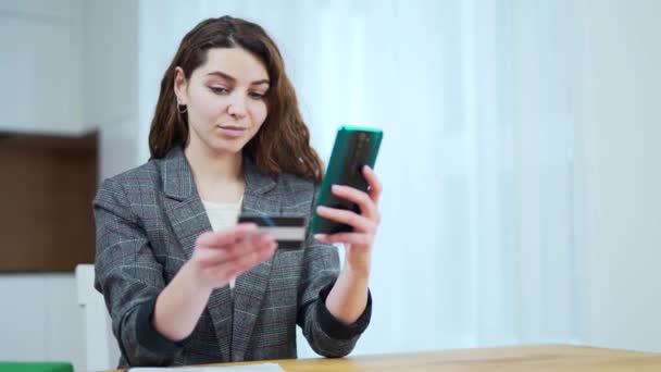 Young Attractive Woman Enters Credit Card Details Mobile Phone Girl — Stock Video
