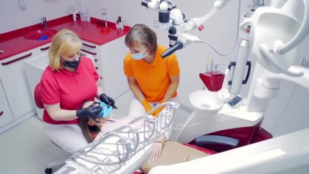 Senior Experienced Female Dentist Fills Canal Modern Equipment Dental Clinic — Stock Video