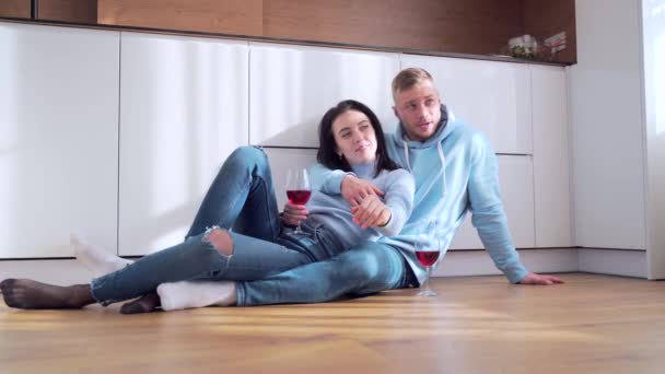 Happy Young Married Couple Sitting Floor Clinking Glasses Wine Celebrating — Stock Video