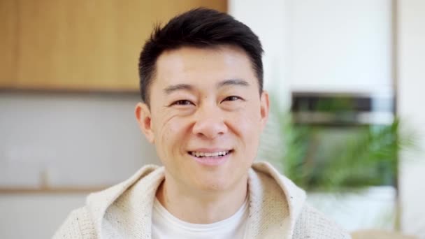 Closeup Portrait Young Asian Guy Looking Camera Smiling While Sitting — Stock Video