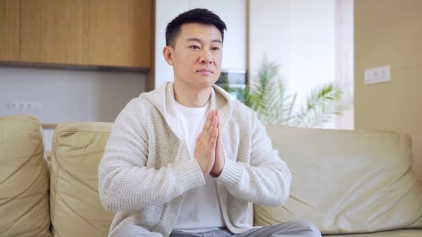 Young Asian Man Praying Home Alone Male Folding Pencil Arms — Stock Video