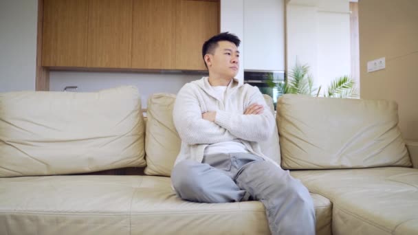 Bored Friends Young Asian Man Sitting Sofa Home Alone Misses — Stock Video
