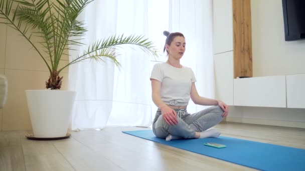 Mujer Atractiva Joven Está Practicando Yoga Línea Utilizando Teléfono Móvil — Vídeo de stock