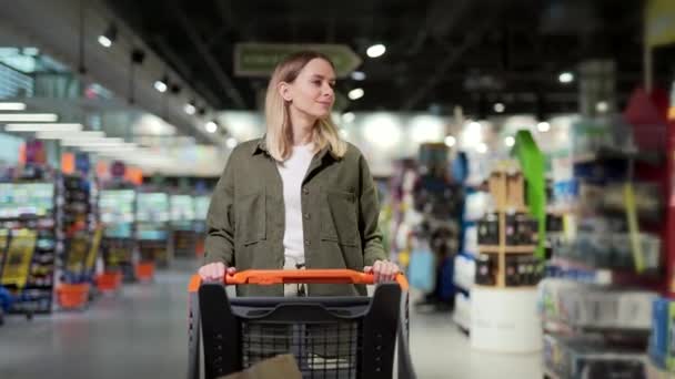 Young Happy Woman Pushing Trolley Spends Time Supermarket Mall Store — Stock Video