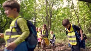 Küçük çocuklar ormanda bir yürüyüşe çıkıyorlar. Vahşi bir anaokulundan gelen çocuklar birlikte orman dağlarında yürüyüş yaparlar. Açık havada küçük bir anaokulu yürüyüşüne katılıyor. Seyahat yaz kampı.